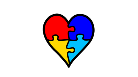 Corazón realizado con cuatro piezas de puzzel de varios colores que simboliza la neurodivergencia