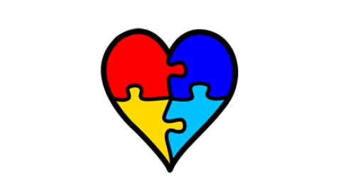 Corazón realizado con cuatro piezas de puzzel de varios colores que simboliza la neurodivergencia