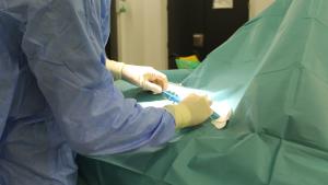 Las manos del médico en quirófano procediendo a poner el holter