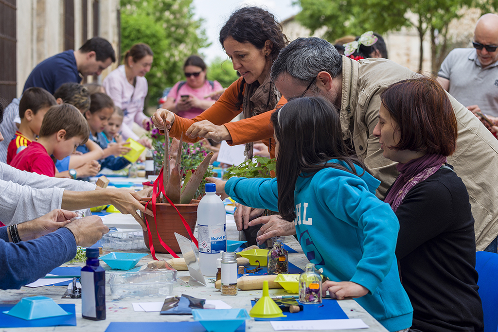 Familiar alrededor de una mesa participando en un taller plástico en Nuevo Baztán