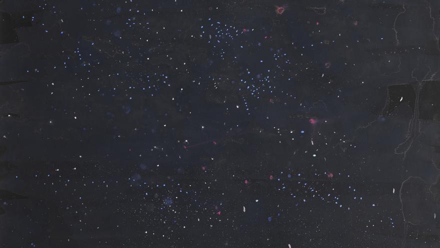 Imagen con fondo negro y pequeños puntos de colores