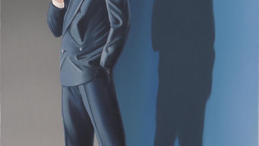 Hombre con traje y cuya cabeza parece formada de ladrillos
