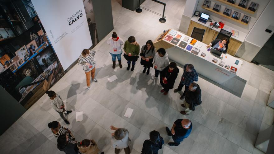 Grupo de personas adultas en círculo haciendo una visita a la expo de Carmen Calvo