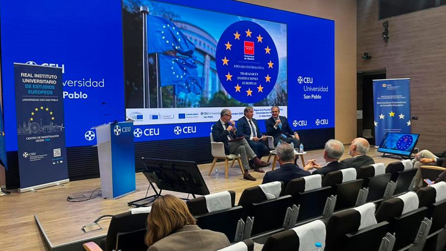 Ponentes en el escenario ante unas filas de asistentes