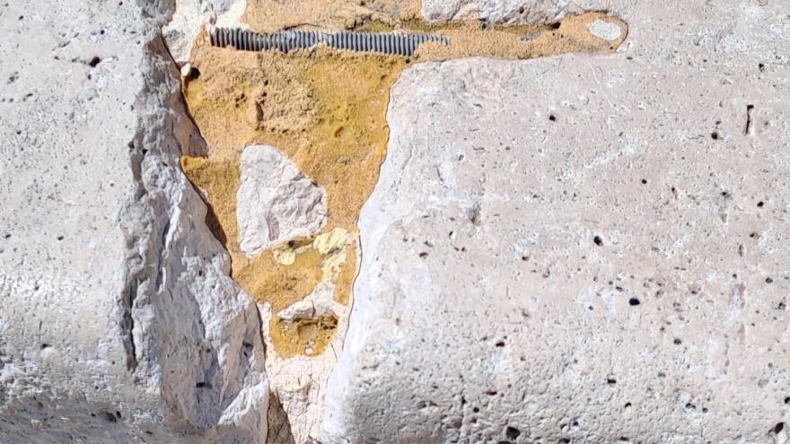 grapa incrustrada en la piedra en mal estado de conservación