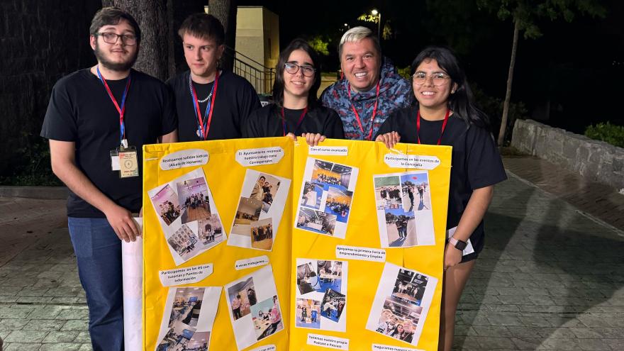 5 Jóvenes sosteniendo cartel amarillo con fotos