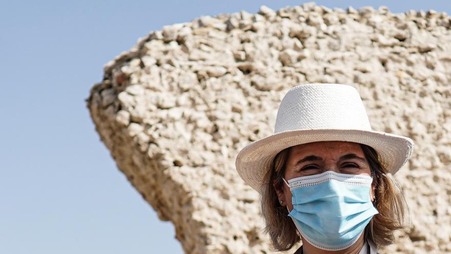 Primer plano de la consejera con un trozo de muralla del yacimiento detrás
