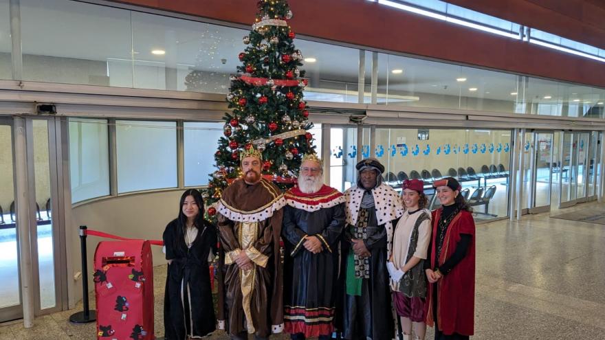 Reyes Magos junto a árbol de navidad en el hall del hospital