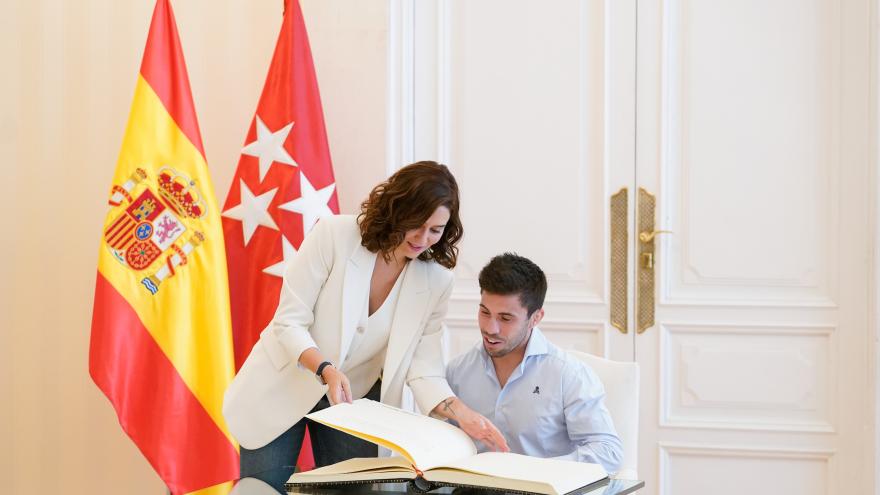 La presidenta le enseña el libro a Garrigós