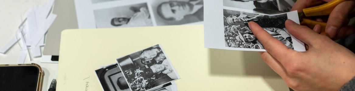 Manos recortando imágenes y componiendo un collage en un libro en blanco