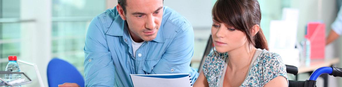 Consejo Asesor de Personas con Discapacidad Mujer con discapacidad consultando documentos junto a un compañero