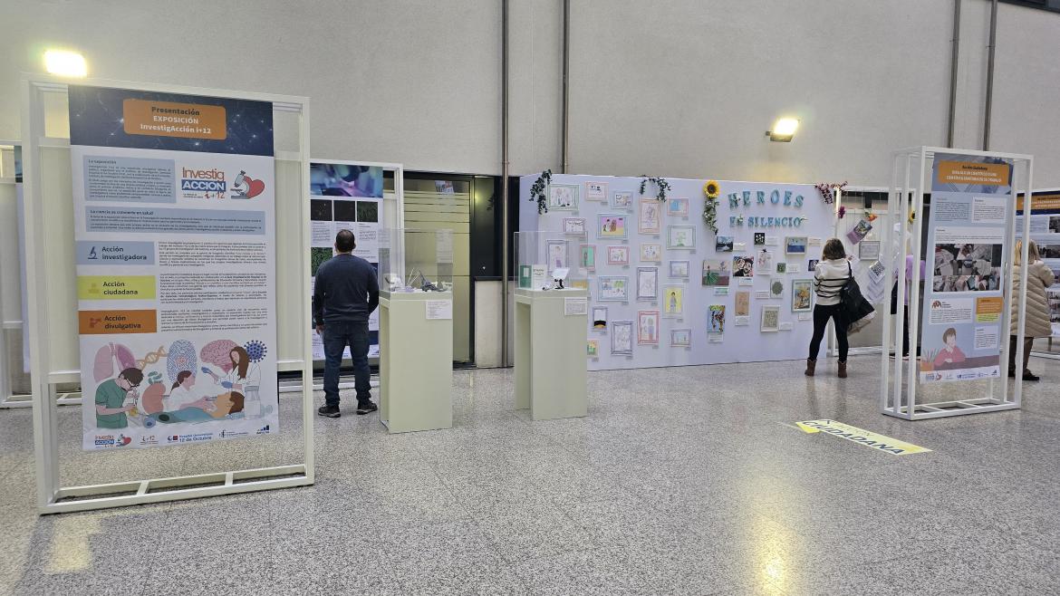 Sala con paneles informativos y tres personas mirando