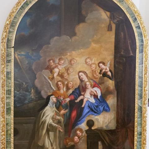 Pintura que representa la virgen María con el niño Jesús recibiendo a una mujer con hábitos religiosos rodeadas por un coro de ángeles